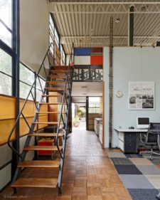 For the first few years after construction was completed, the Eames House studio’s second story loft was only accessible by a painter’s ladder. By 1955, this simple staircase consisting of wooden treads, open risers, and pipe handrails was installed. Photograph by Mitsuya Okumura © @EamesOffice #eames #eameshouse #charleseames #rayeames #charlesandrayeames #casestudyhouse #modern #architecture #california #losangeles